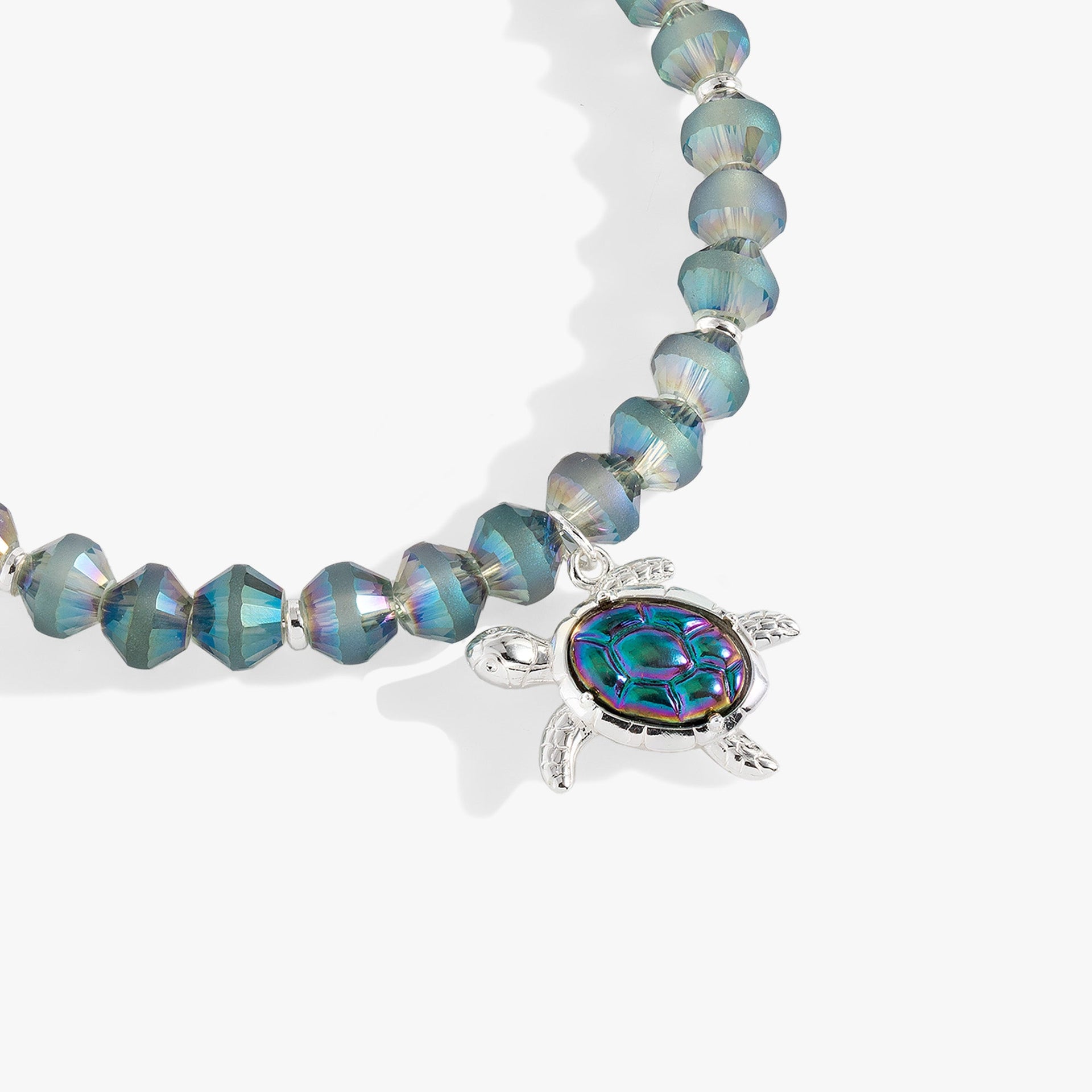 Sea Turtle Beaded Bangle featuring a transparent blue turtle charm in a silver-tone setting.