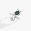 Close up of a Sea Turtle ring featuring a blue cabochon shell and a faceted clear crystal accent.