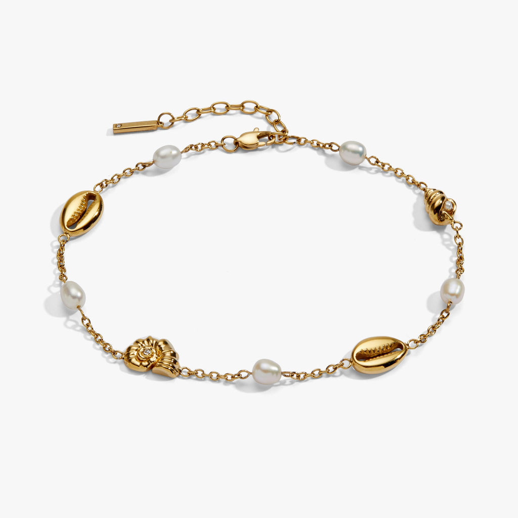 Bohemian-style gold-tone anklet with white freshwater pearls and seashell charms.