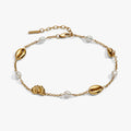 Bohemian-style gold-tone anklet with white freshwater pearls and seashell charms.