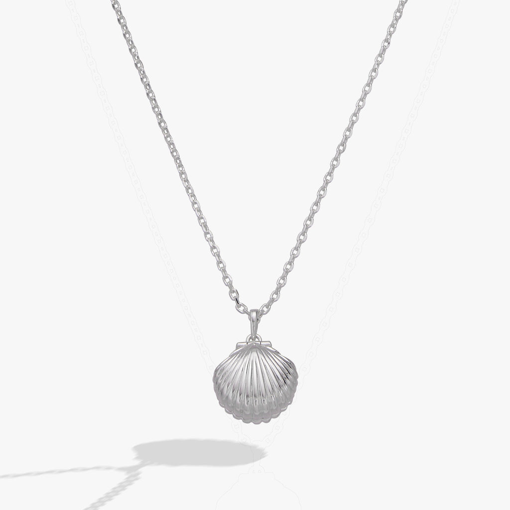 Alex And Ani seashell locket pendant featuring a pearl accent and engraved hidden message
