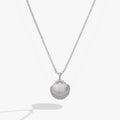 Alex And Ani seashell locket pendant featuring a pearl accent and engraved hidden message
