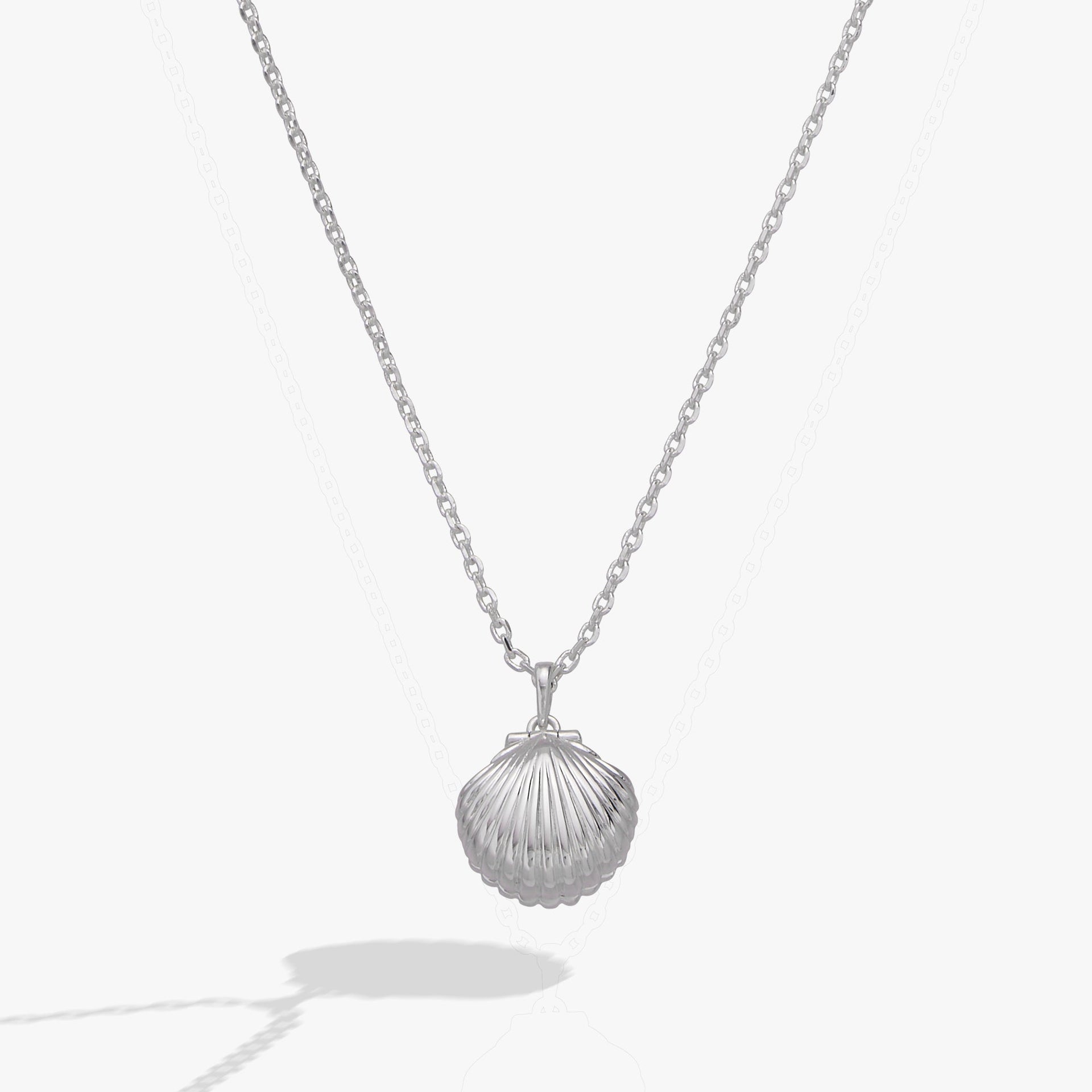 Alex And Ani seashell locket pendant featuring a pearl accent and engraved hidden message