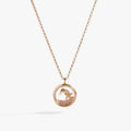 Gold circle pendant necklace filled with sand, pearl, seashell, and starfish charm.