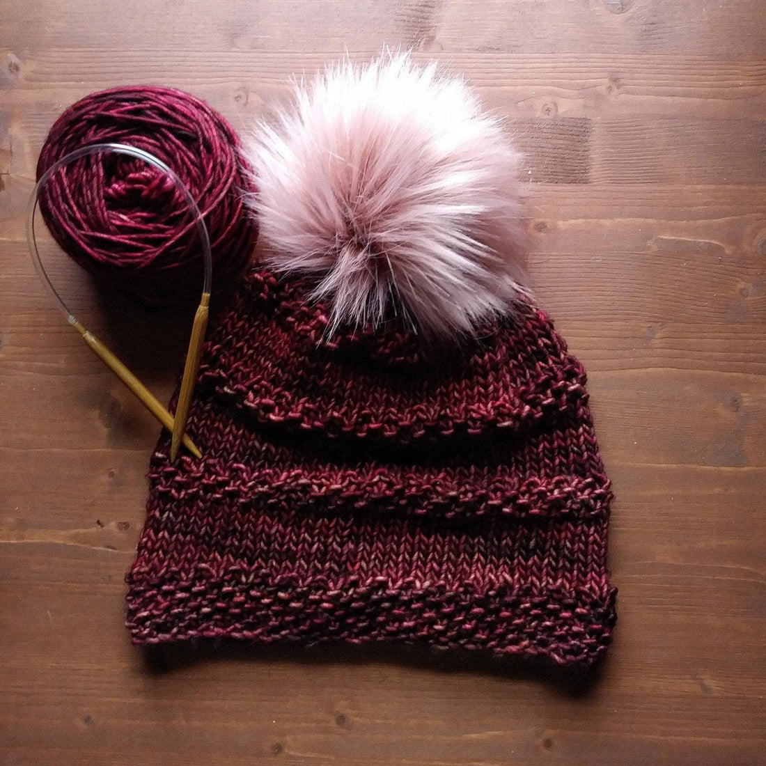 Close up of a hand-knitted beanie with ridge detailing made from the Seed Ridge Beanie Knitting Pattern