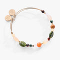 A multi-stone nugget gemstone bangle bracelet featuring Red Aventurine, Jasper, and Qing Hai Jade beads.