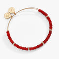 Red semi-precious rondelle beaded bangle with gold-tone spacers and clear crystals