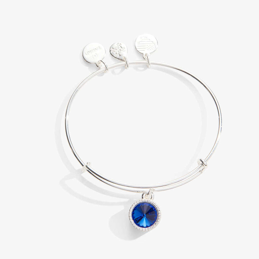 September birthstone sapphire charm bangle on a gold-tone wire base