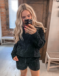 Model wearing soft black knit sweater shorts with a relaxed, comfortable fit.