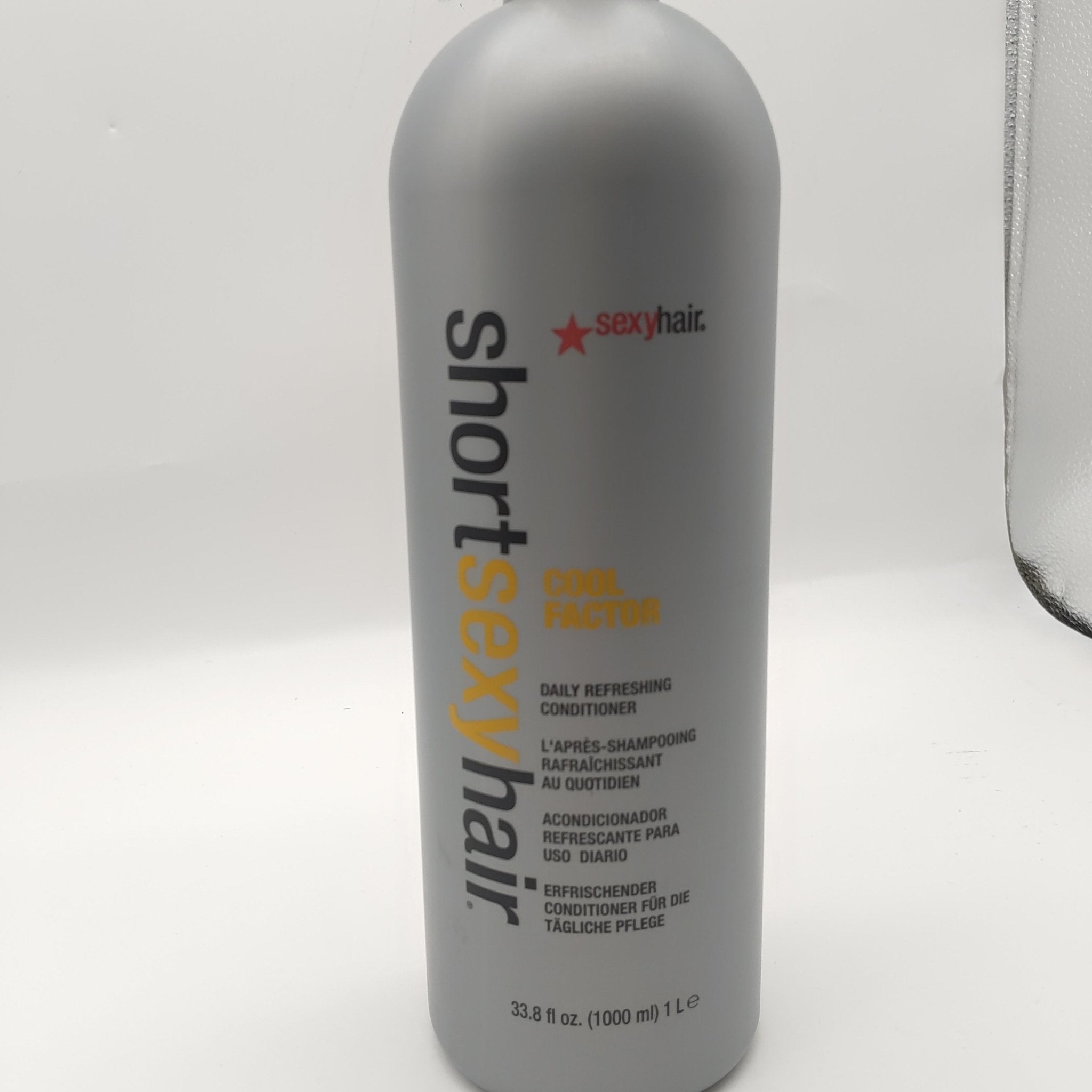 Bottle of Short Sexy Hair Cool Factor Daily Refreshing Conditioner, grey and orange packaging, 33.8 oz.