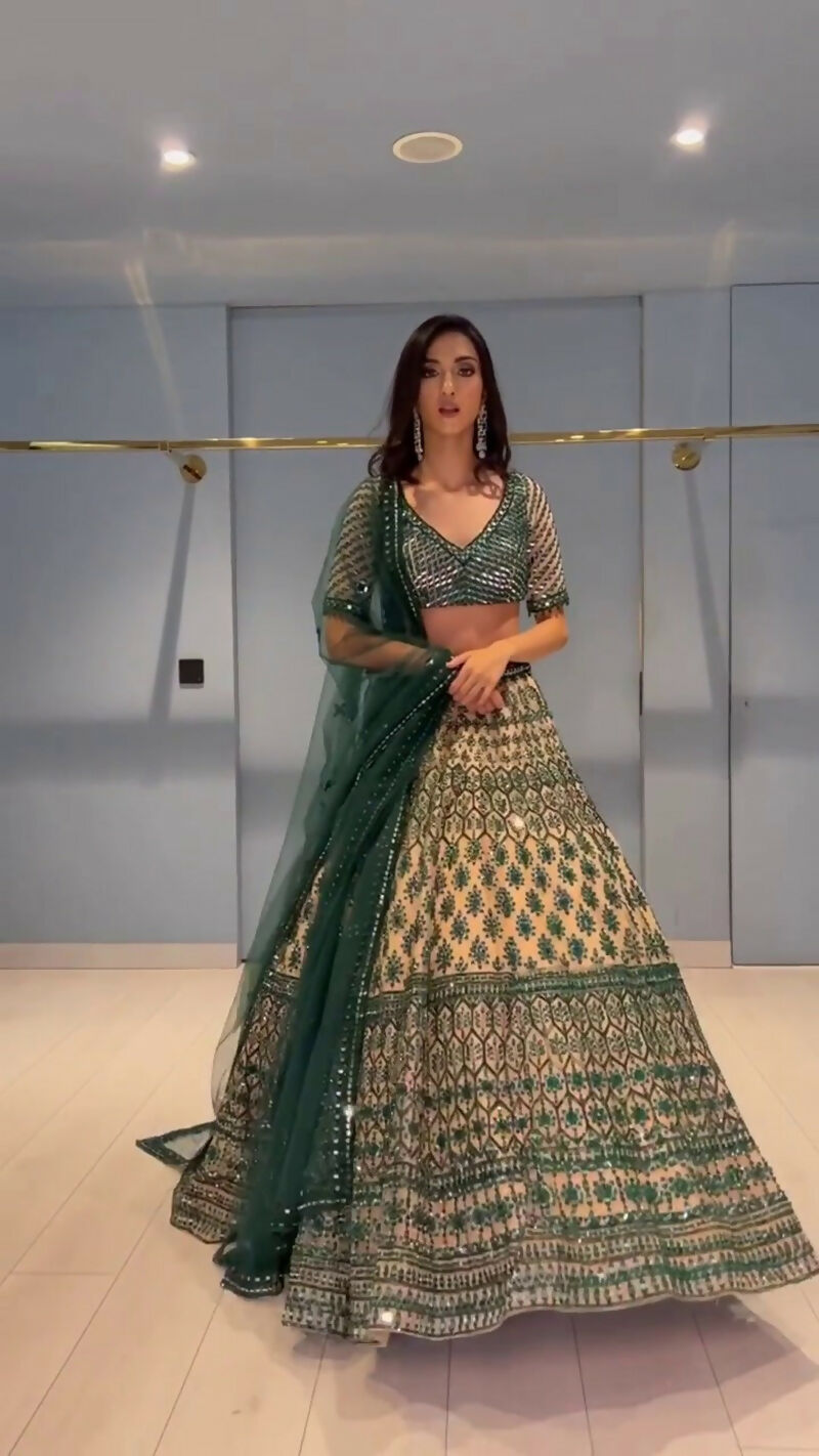 Teal green and cream georgette designer lehenga choli with detailed sequin and thread work.