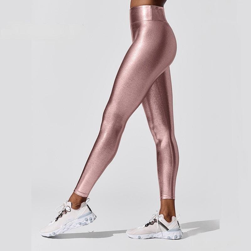 Woman wearing metallic luster high-waist compression leggings for yoga and gym activities