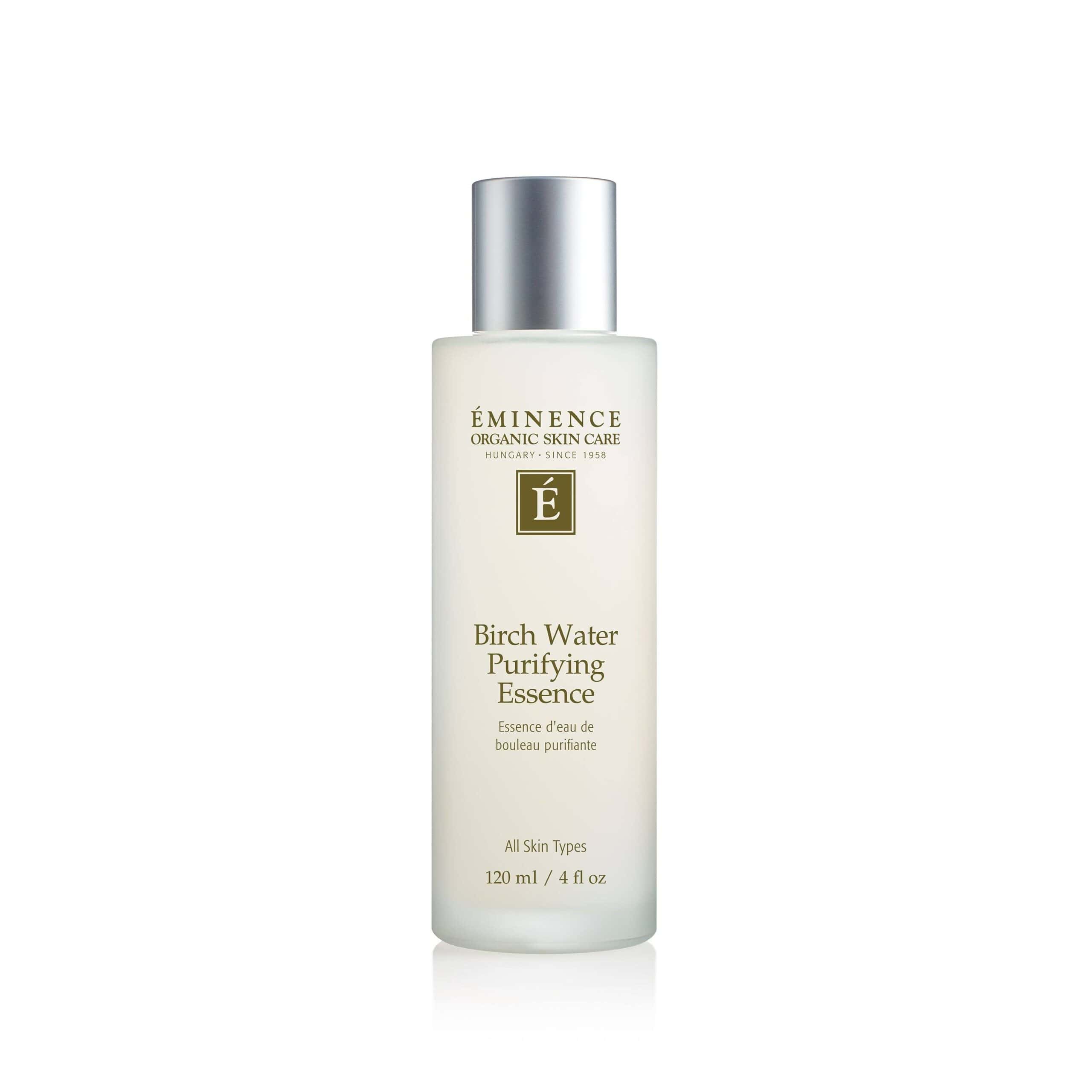 A frosted glass bottle of Eminence Birch Water Purifying Essence with a silver metallic cap against a minimalist background.