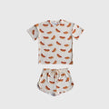 Girl wearing a two-piece bamboo short set with a colorful hot dog print