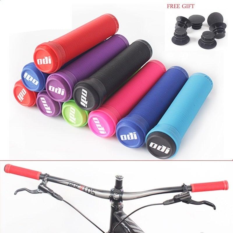 Ergonomic silicone foam bicycle handlebar grips with bar end plugs in a sleek weather-resistant finish.