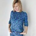 Classic relaxed fit women's crew neck sweater with three-quarter sleeves in an abstract blue, green, and purple knit pattern.