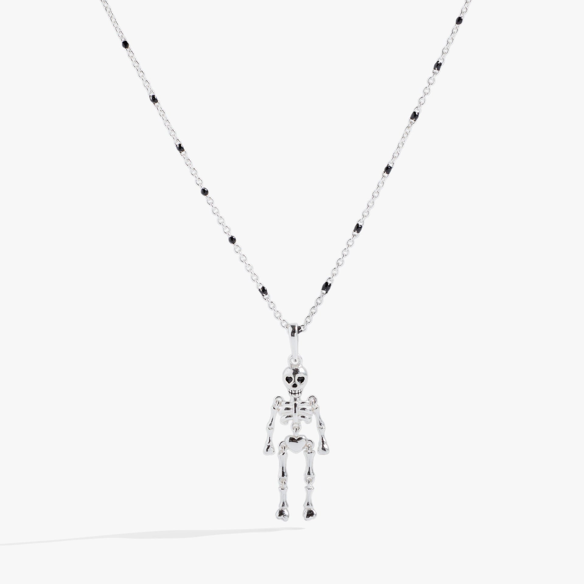 Modern skeleton pendant necklace with jet black beads on a silver chain.