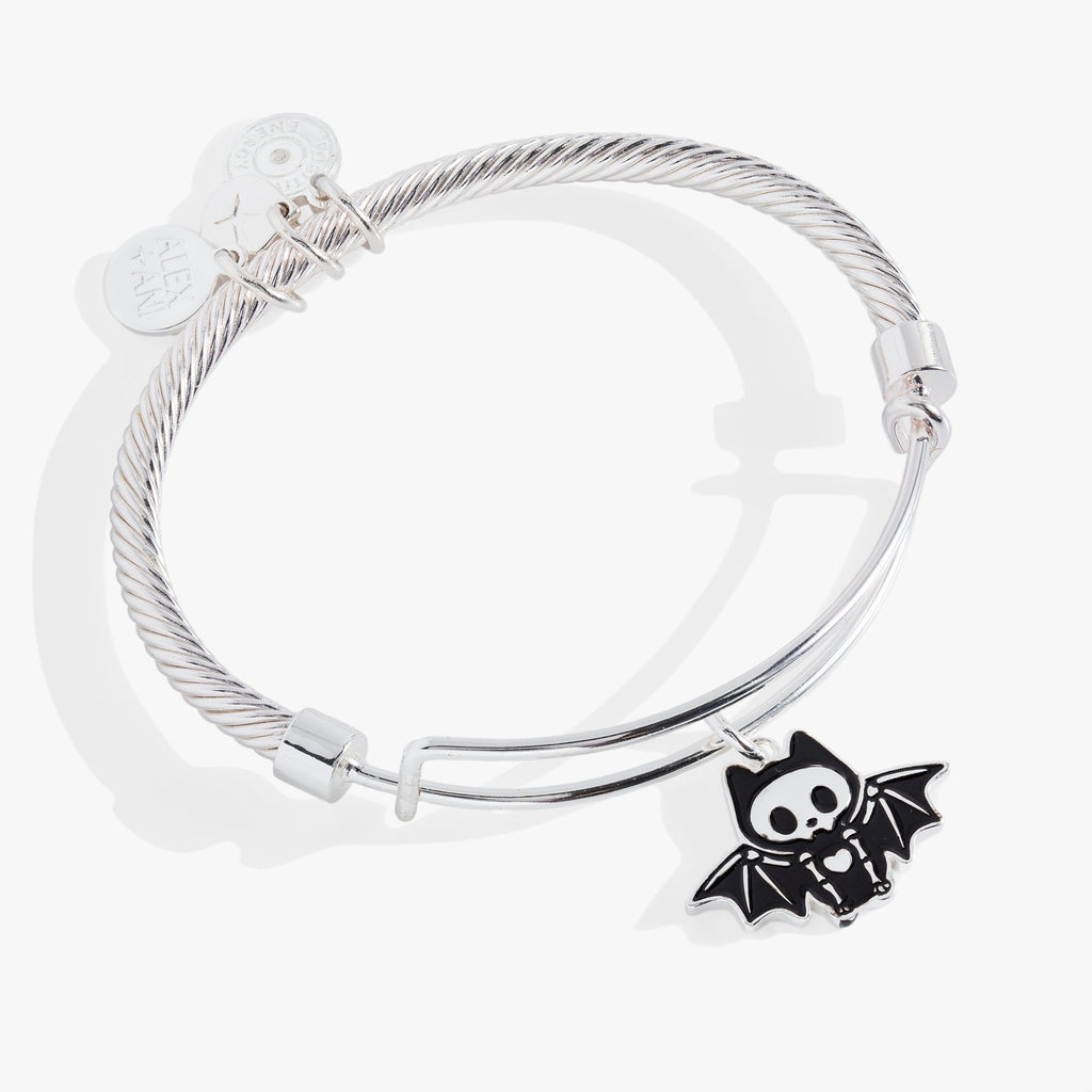 Silver-tone twisted wire bangle featuring a smiling bat skeleton charm with wings spread wide.