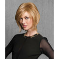 Woman wearing a Sleek & Chic textured synthetic bob wig in blonde and brown
