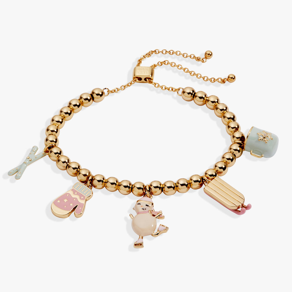 Winter Wonderland bolo bracelet featuring enamel charms of a snowman, skis, and mittens.