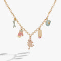 Winter Wonderland gold charm necklace with pastel pink and blue enamel charms including snowwoman, sled, and hot cocoa.
