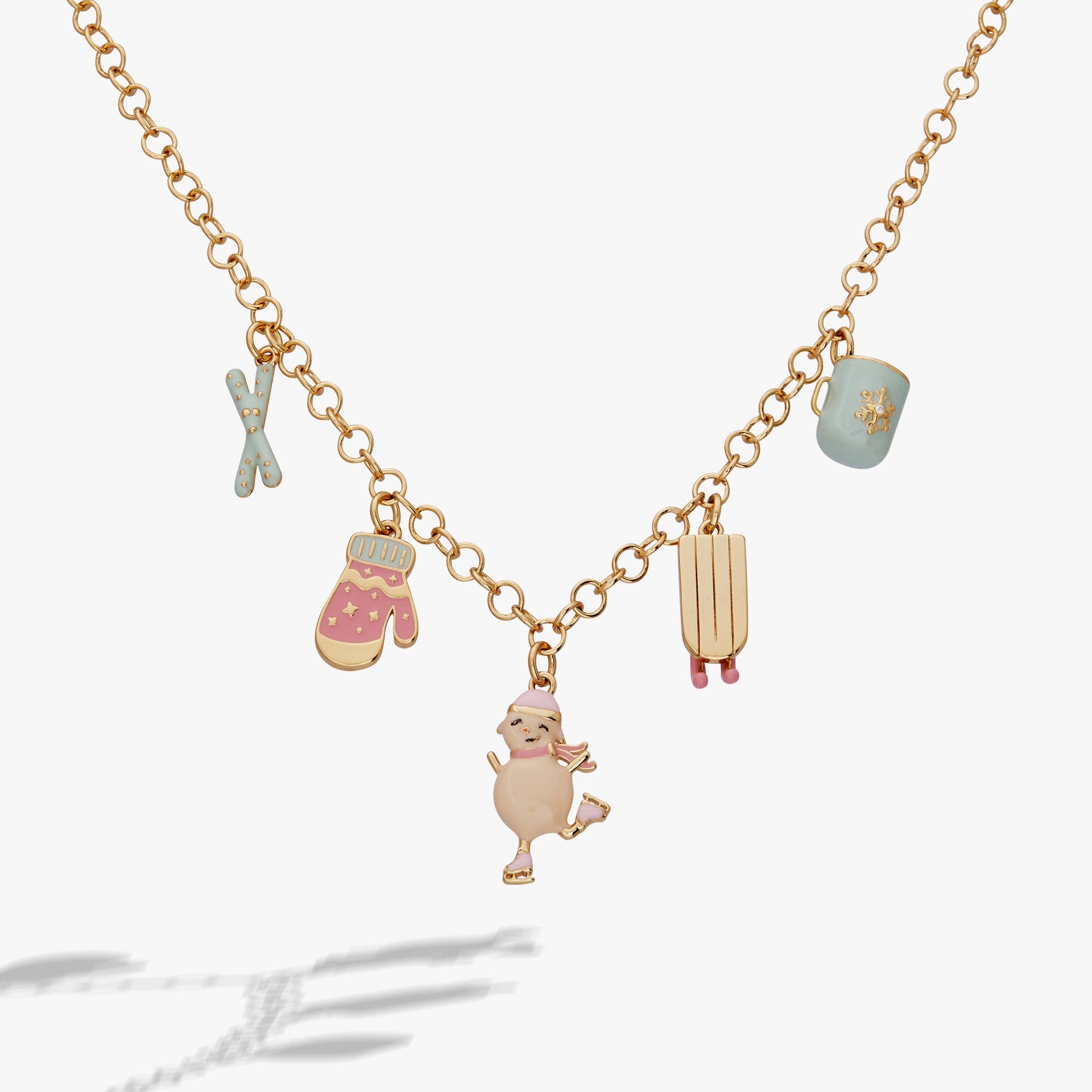 Winter Wonderland gold charm necklace with pastel pink and blue enamel charms including snowwoman, sled, and hot cocoa.