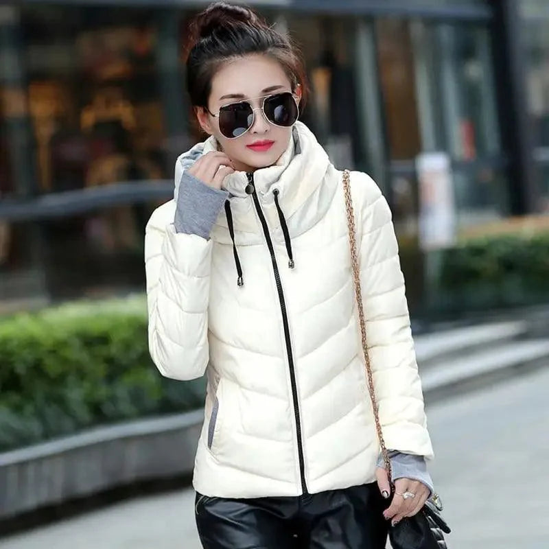 Woman wearing a short hooded padded winter jacket available in white, yellow, red, and pink