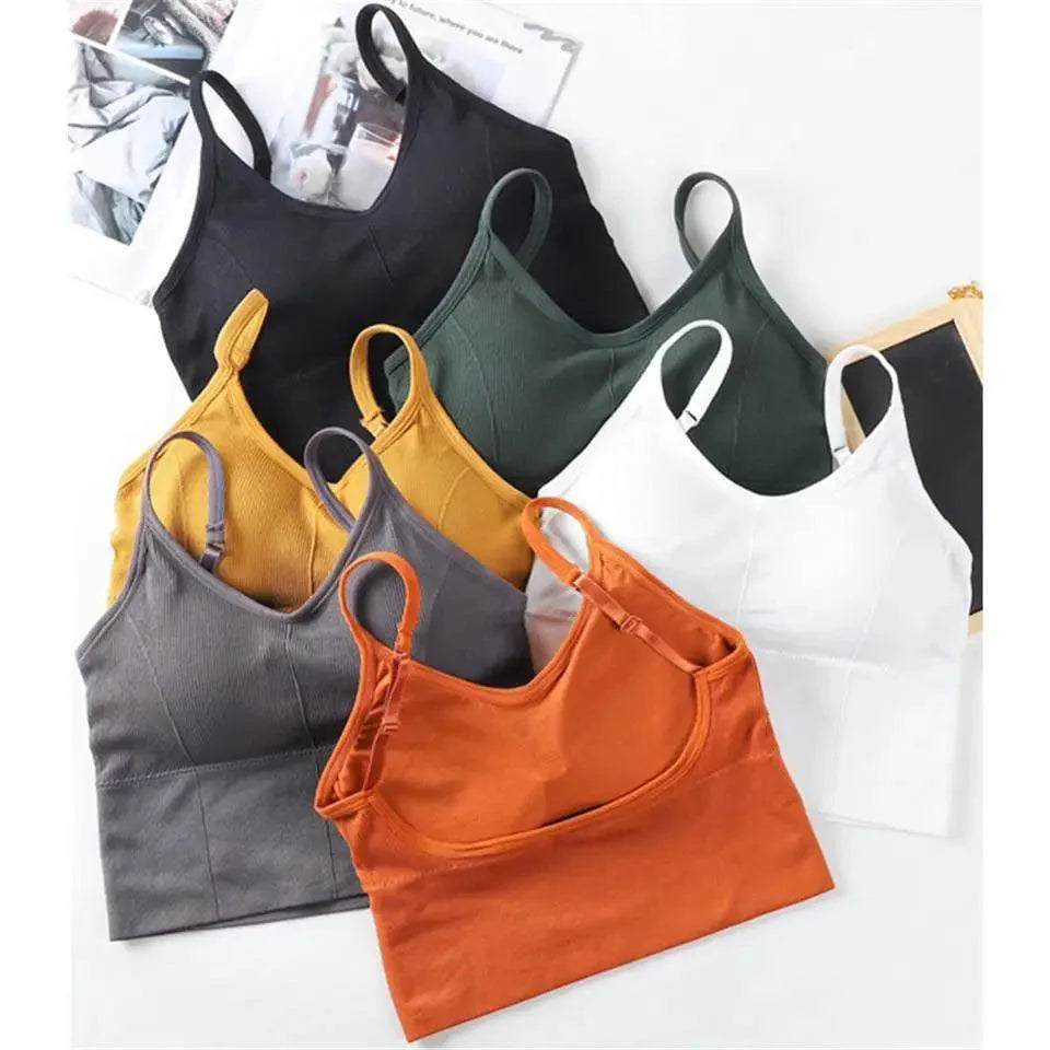 A woman wearing a fitted, cropped V-neck sports bra with crisscross back straps in an earthy olive tone.