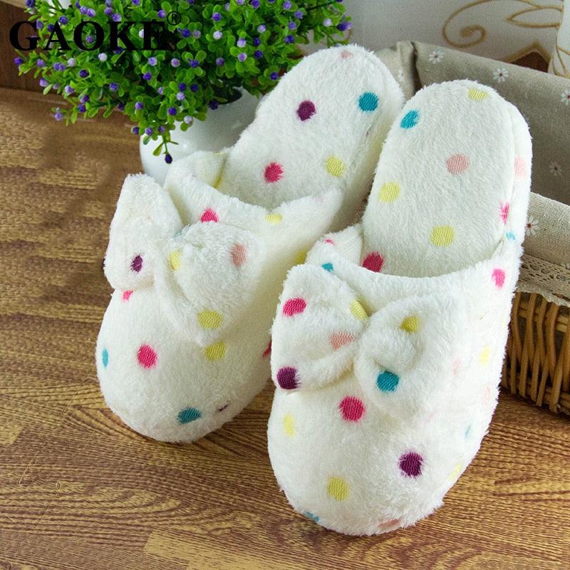 Close up of plush, fur-lined women's slippers with memory foam insole and slip-on design.