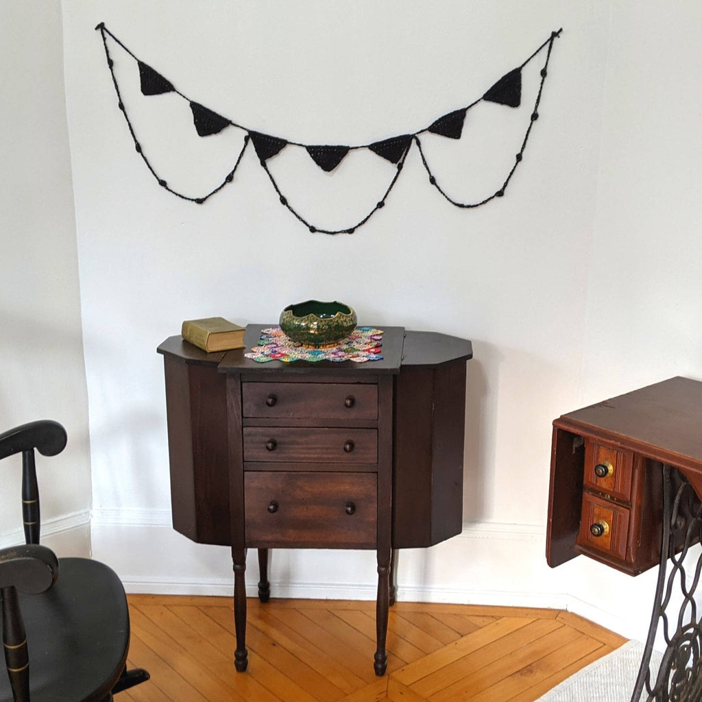 Spooky Chic Halloween Bunting Crochet Kit featuring two completed DIY banners