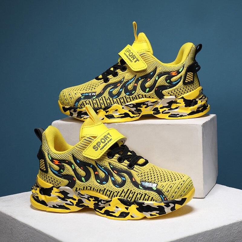 Kids wearing stylish yellow and black knit athletic sneakers with flame-graphic details.