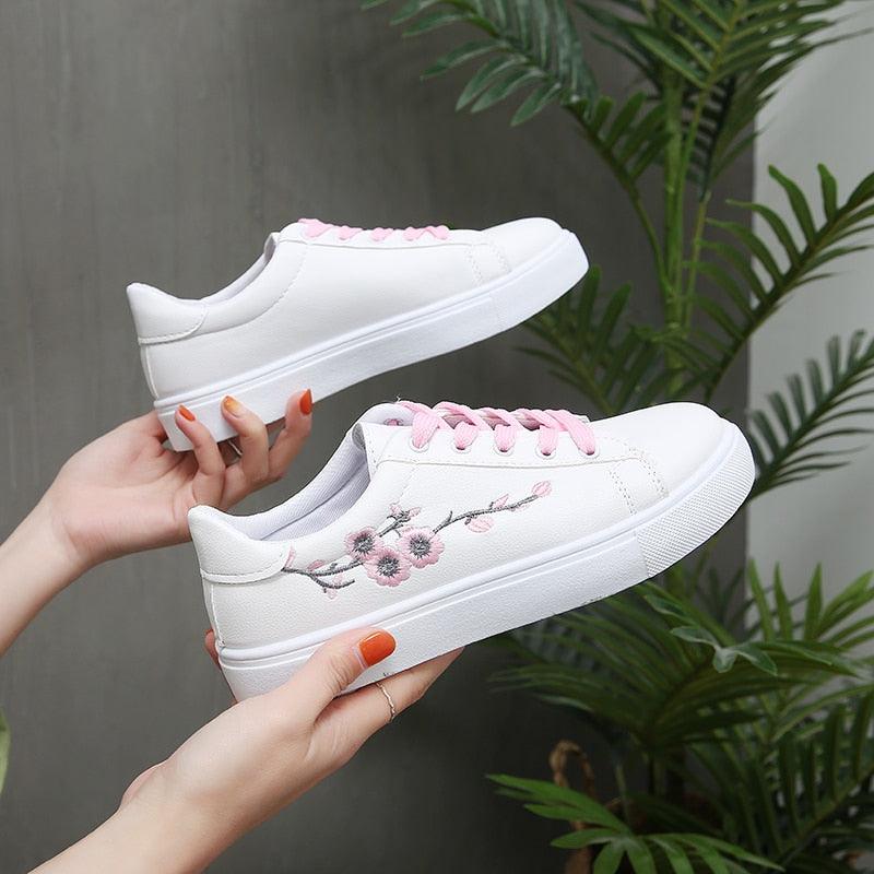 Side view of women's white PU leather platform sneakers with lace-up closure