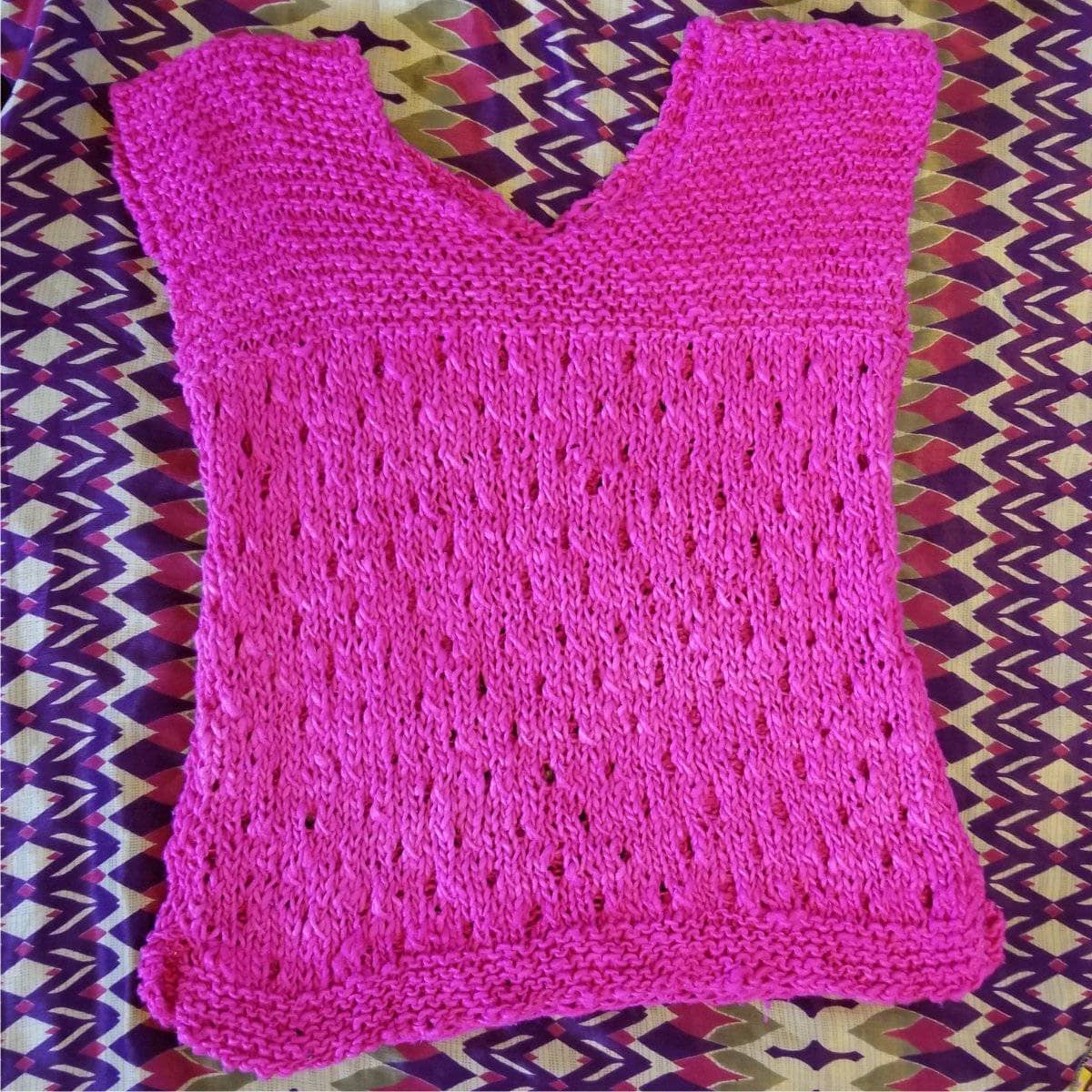 A stylish, hand-knitted tee featuring the Spring Fling pattern design.