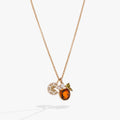 Gold necklace featuring an Aperol Spritz cocktail charm with orange, green, and yellow crystal details.