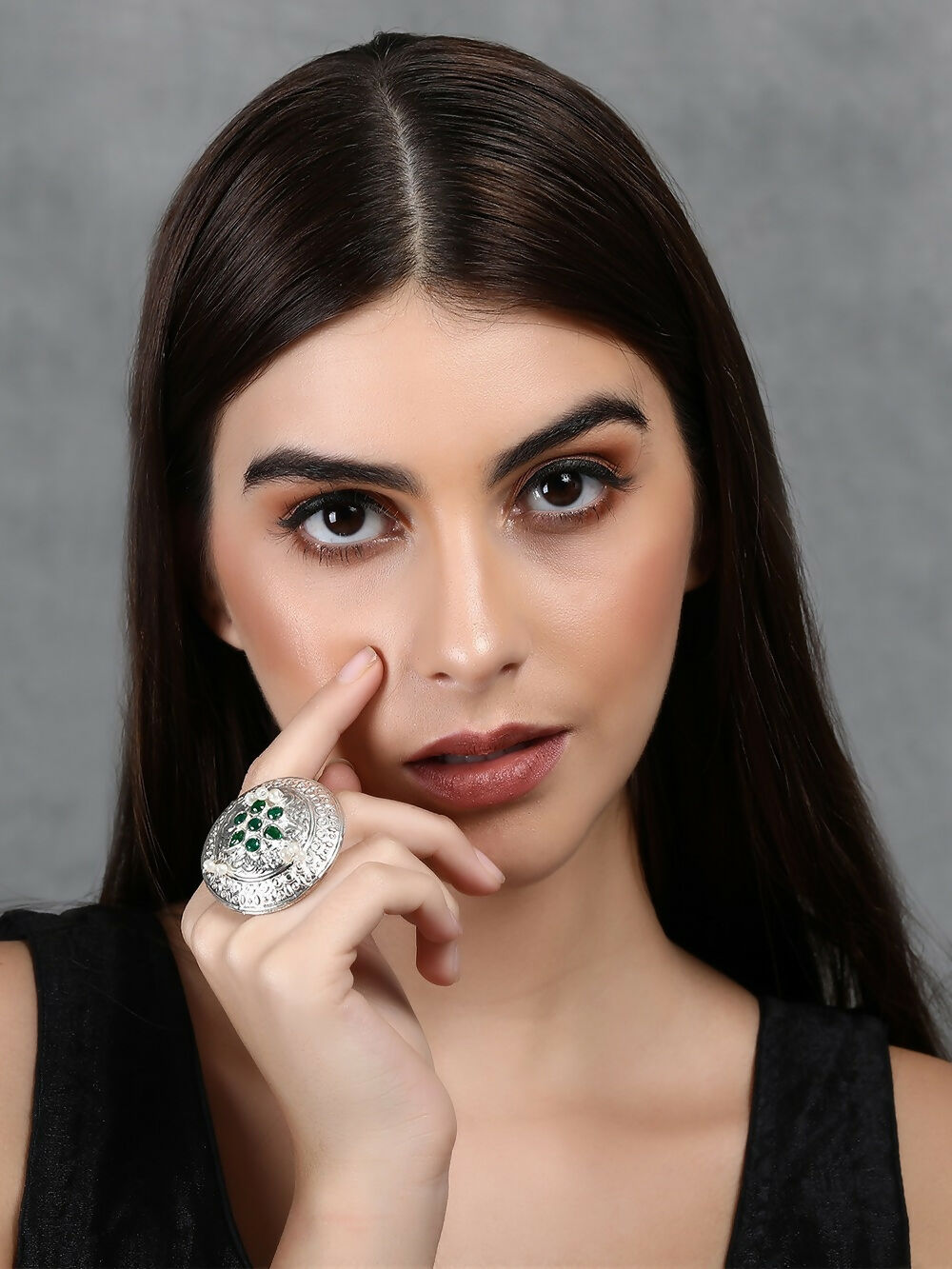 Handcrafted silver tone ring with intricate patterns and green stone setting