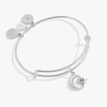 Celestial moon and star charm bangle bracelet on a simple background
