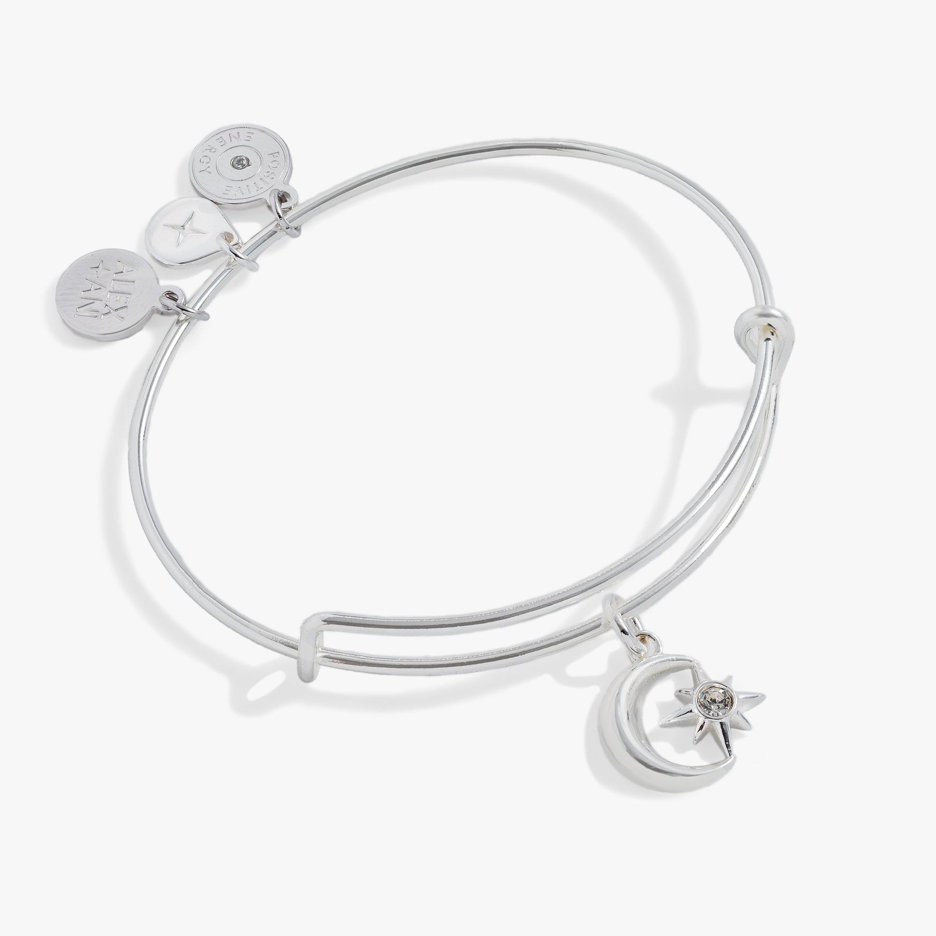 Celestial moon and star charm bangle bracelet on a simple background