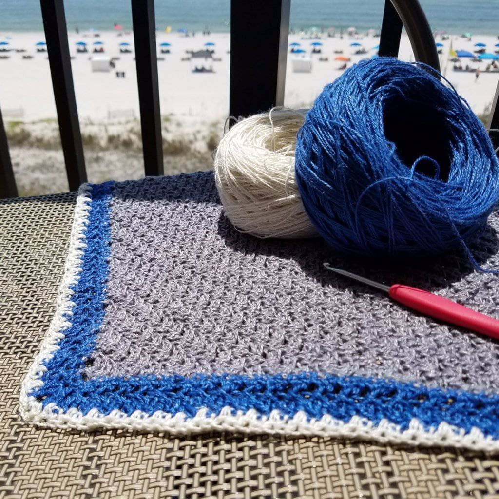 Stingray Shawl Crochet Kit with grey, blue, and cream yarn skeins for a handmade bohemian fringe shawl