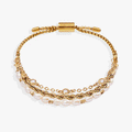 Three-piece layered bracelet set featuring freshwater pearls, a rope chain, and glass crystal stones.