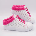 White slip-on fashion sneakers with silver studs and hot pink fleece trim on a white background