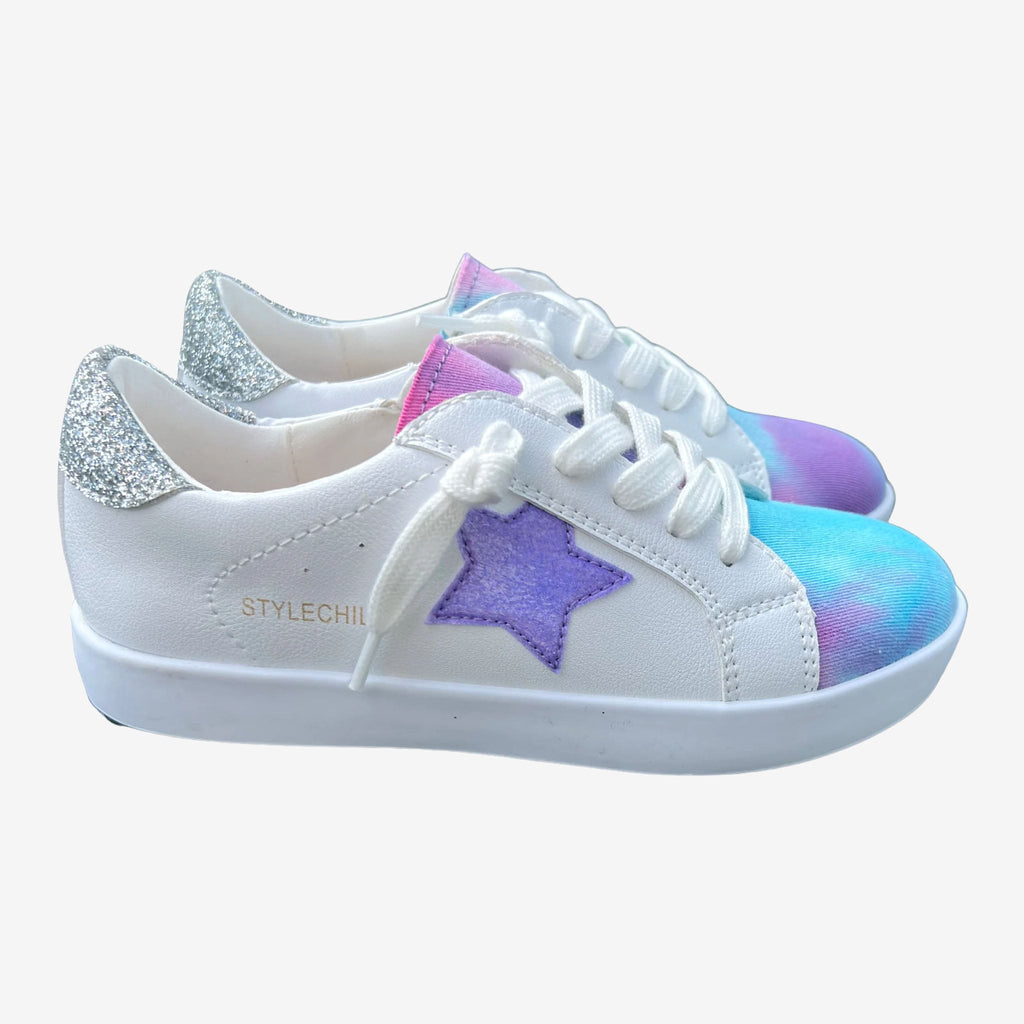 White PU leather sneakers with a colorful tie dye toe, purple glitter star, and silver glitter heel grip.