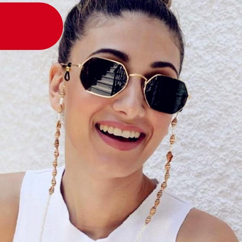Woman wearing stylish gold hexagon metal frame sunglasses for summer travel