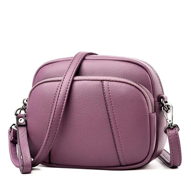 Stylish soft leather cross-body shoulder bag featuring gold hardware and an adjustable strap