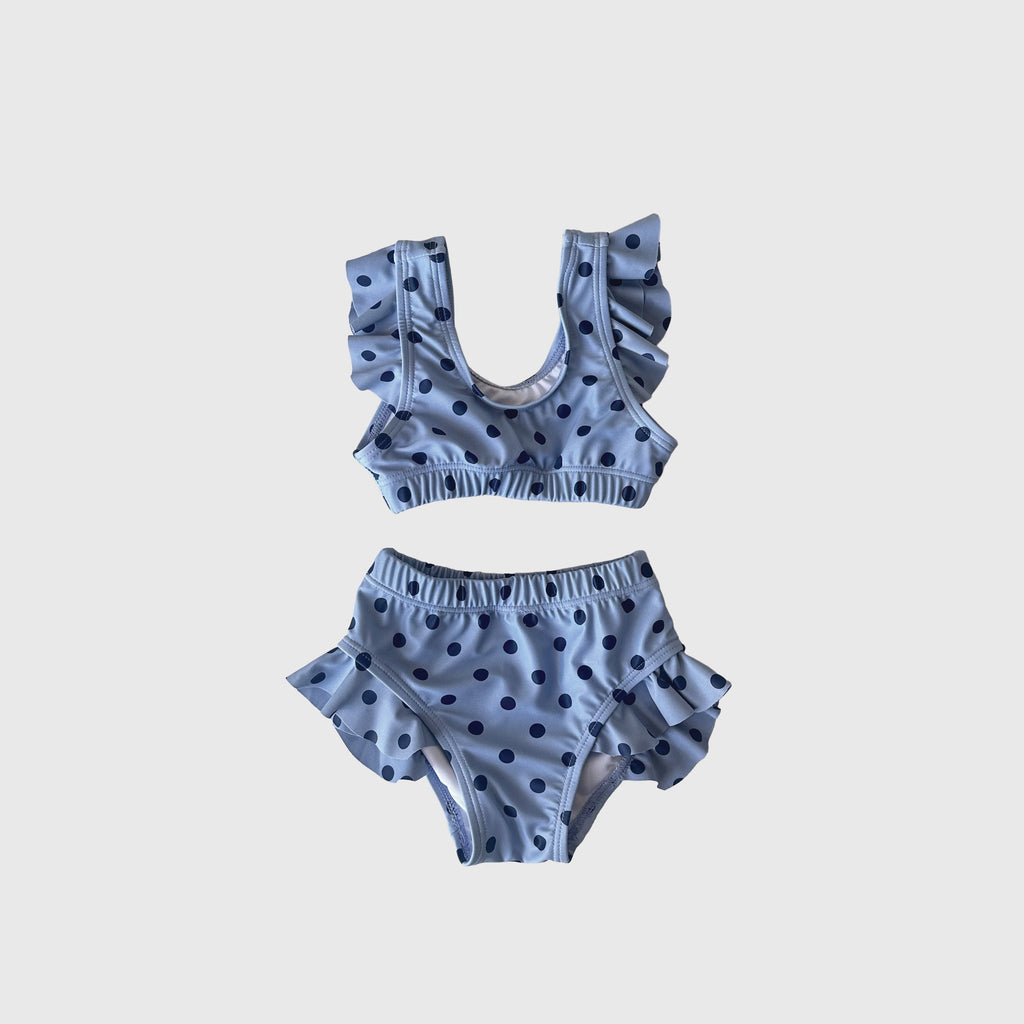 Girl's two-piece swimsuit in a light blue and navy polka dot print