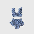 Girl's two-piece swimsuit in a light blue and navy polka dot print
