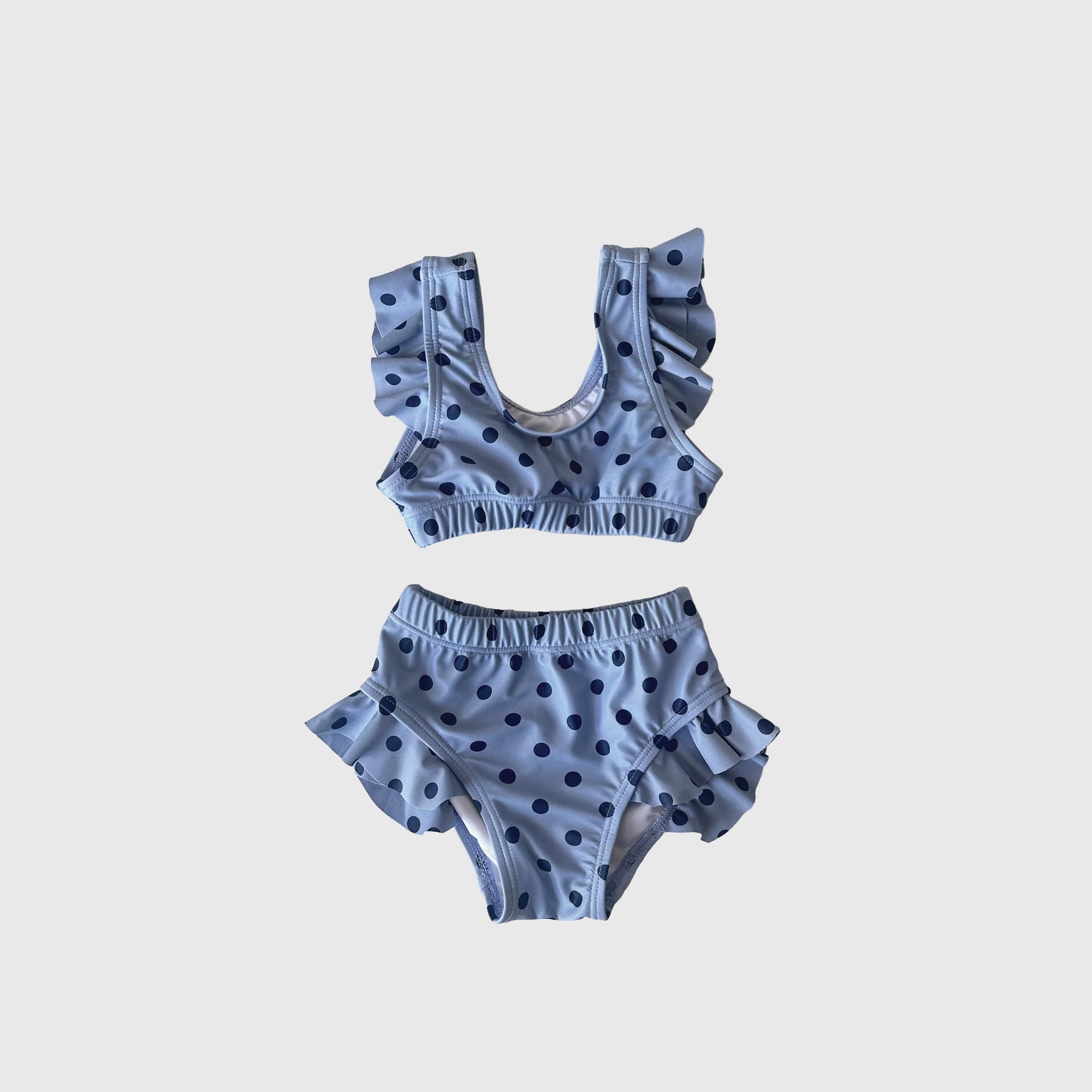 Girl's two-piece swimsuit in a light blue and navy polka dot print
