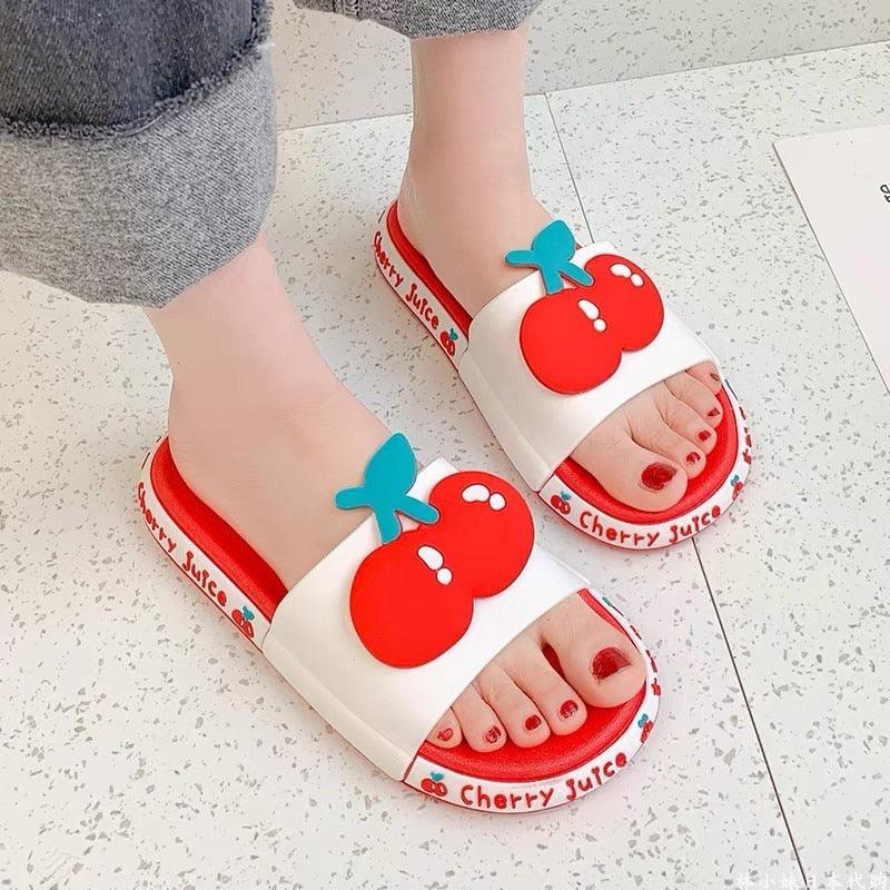 Close-up of lightweight fruit-themed beach slides with non-slip traction soles for kids.