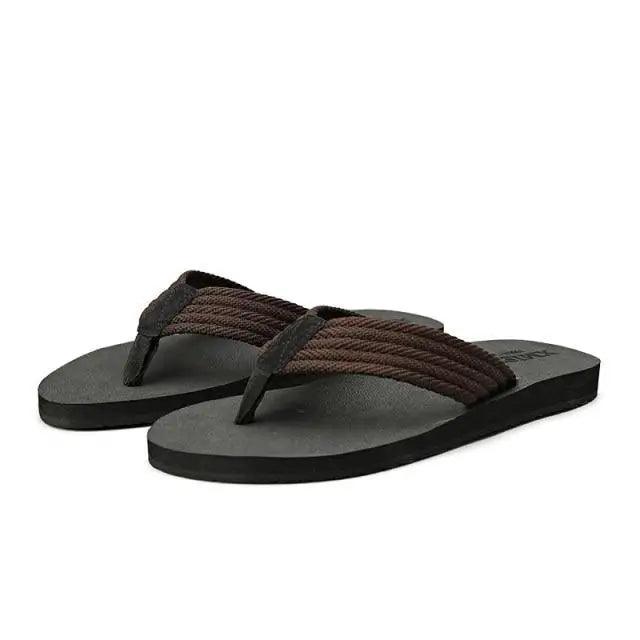 Men's black casual flip-flops with soft cotton straps and herringbone textured toe post for beach and pool use.
