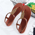 A pair of women's geometric pattern flat thong sandals in black and brown.