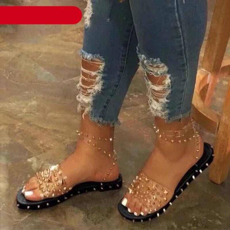 Women's flat sandals with transparent straps and adjustable ankle buckle closure
